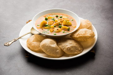 Aloo Puri or Potato curry with fried Poori, popular Indian breakfast / lunch / dinner menu.