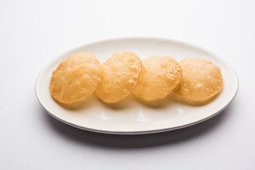 Plain Puri served in a plate. It's an Indian deep-fried bread made from whole-wheat flour, popular main course or breakfast recipe 