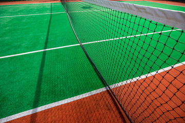 Tennis clay court. Abstract tennis court background, closeup with sunlight