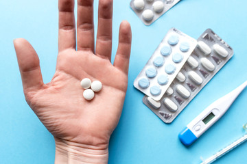 White pills in the hand. Treatment and pharmacy concept. Top view.