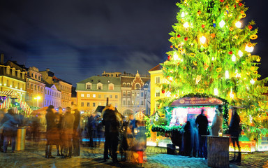 Naklejka na ściany i meble People on Christmas market in night Riga