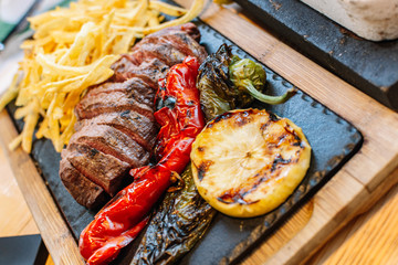 grilled vegetables and meat. Potatoes, peppers, barbecue steak. food close-up