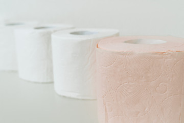 Rolls of toilet paper. A lot of toilet paper is standing nearby. Purchasing toilet paper