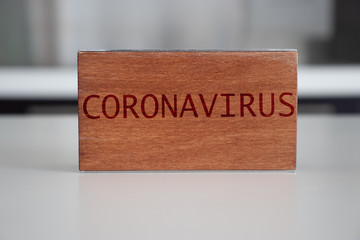 Coronavirus word at wooden block. Coronavirus text on