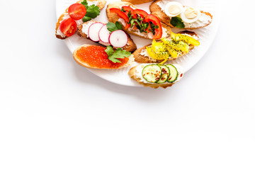 Set of bruschetta on plate on white background copy space
