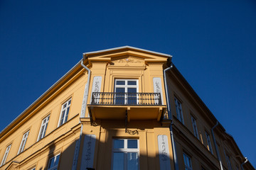 Fototapeta na wymiar Old tenement house illuminated by bright sun light.