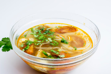 Tom yum (Tom Yam) soup with chicken and squid on top on white background