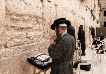 Believer Orthodox Jew prays near the Kotel in the Old Town of Jerusalem in Israel