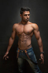 Tanned trainer body builder posing athletic body