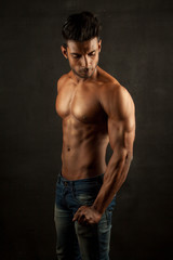 Fototapeta na wymiar Tanned trainer body builder posing athletic body