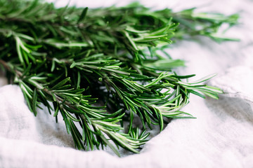A bunch of fresh rosemary on the table.