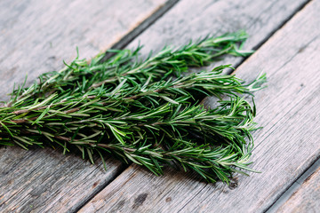 A bunch of fresh rosemary on the table.