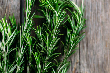 A bunch of fresh rosemary on the table.