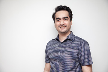 Middle East Asian man dressed casually for office work.