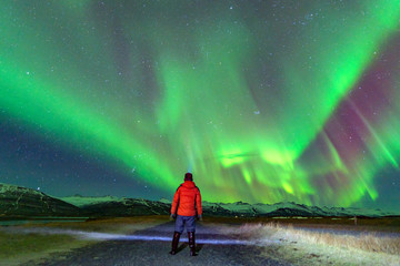 Level 5 Aurora rising above a beautiful mountain. In iceland
