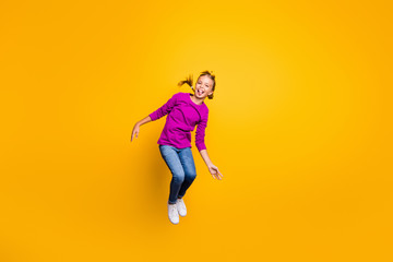 Fototapeta na wymiar Full length body size view of her she nice attractive lovely childish playful cheerful cheery girl jumping grimacing fooling having fun isolated on bright vivid shine vibrant yellow color background