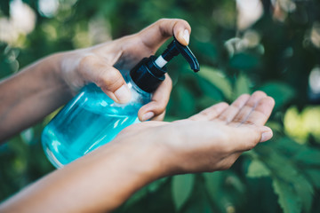 woman disinfecting his hands with hand sanitizer and protection against viruses and bacteria