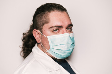 Medical stock photography wearing blue mask and white coat with green eyes.