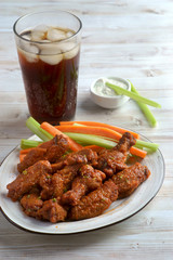 Buffalo chicken wings with vegetables and Cola