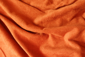 Jammed bright reddish orange artificial suede fabric