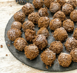 chocolate truffle on black plate