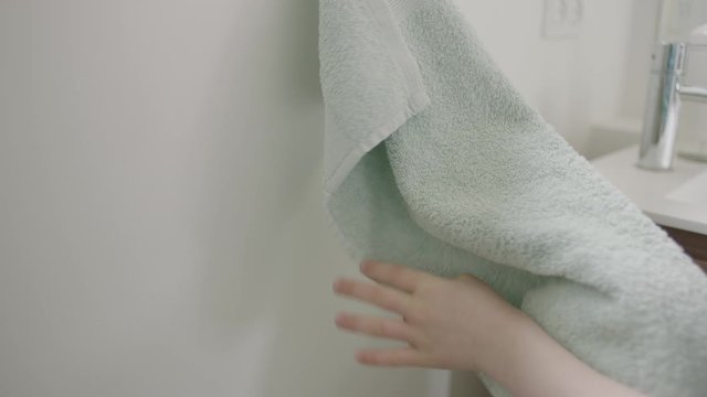 Boy Drying Hands On Bathroom Towel