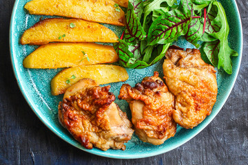 fried chicken and potatoes, keto or paleo diet menu concept food background. top view. copy space for text