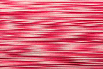 Pink gluten-free wholemeal spaghetti textured background seen from above. Gluten-free healthy food concept