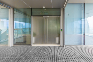 A modern office building with glass doors and windows