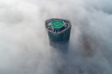 Helipads on the roofs of urban high-rise buildings shrouded in advection fog  © hrui