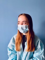 a teenage giwl wearing a medical mask during corona virus quarantine time trying to get escaped