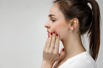 young sad woman suffering from tooth pain, caries. girl having toothache. Dental health and care...
