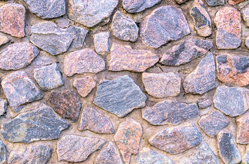 Vintage texture of stonework old masonry. Granite Cobblestone Wall