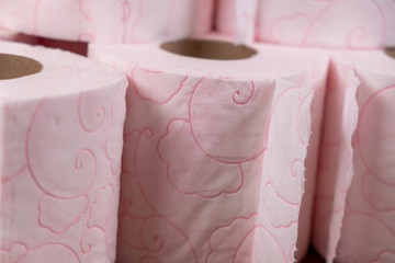 Lots of toilet paper rolls. soft hygienic paper. Pink toilet paper close up