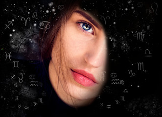 Female face against the background of space and astrological symbols