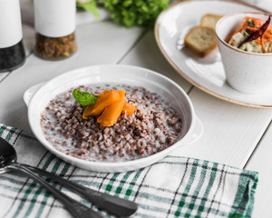 Buckwheat porridge in a plate, restaurant menu. Scanty product. Healthy diet food.