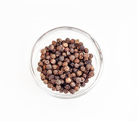 Small pile of black pepper isolated on white background.