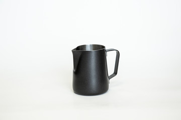Black Metal pitcher for coffee making. Barista tool. Milk pitcher. on white background