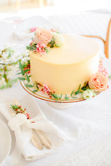 Fototapeta na wymiar Yellow wedding cake with flowers