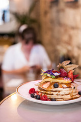 Pancakes with berries and edible flowers