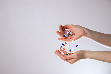 A lot of colorful Levitation medication and pills sprinkle in hands. Taking Your Medication.