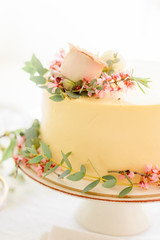 Yellow wedding cake with flowers