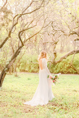 bride in white dress in park