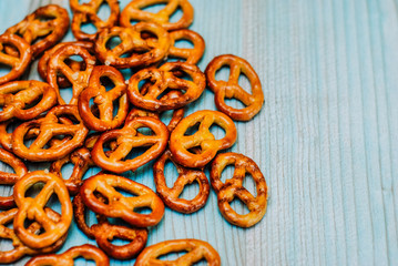 Food snack Salted crispy Pretzel on blue background with copy space