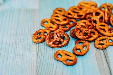 Food snack Salted crispy Pretzel on blue background with copy space