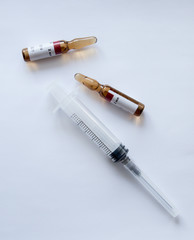 ampoules and syringe on a white background