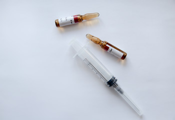 ampoules and syringe on a white background
