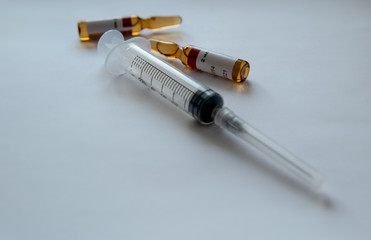 ampoules and syringe on a white background