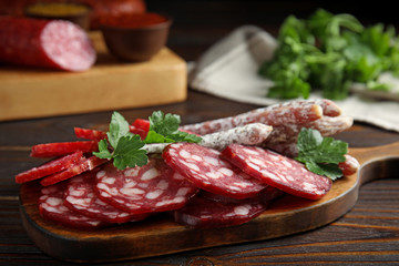 Different types of sausages served on wooden table, closeup