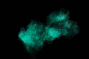 Fototapeta na wymiar Aquamarine powder explosion on black background. Colored powder cloud. Colorful dust explode. Paint Holi.